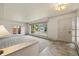 Large bright living room featuring neutral walls and carpet and an entrance door at 937 S Cole Dr, Lakewood, CO 80228