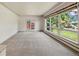 Bright living room featuring large windows with backyard views and neutral carpet at 937 S Cole Dr, Lakewood, CO 80228