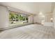 Bright living room with large window and neutral carpeting at 937 S Cole Dr, Lakewood, CO 80228