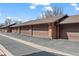 Row of single-car garages, featuring brown doors and brick facade, for convenient parking at 501 Manhattan Dr # 202, Boulder, CO 80303