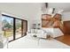 Bright living room boasts a vaulted ceiling, sliding glass doors to deck, and elegant staircase at 501 Manhattan Dr # 202, Boulder, CO 80303