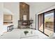 Bright living room with a stone fireplace and sliding glass doors leading to a wood deck at 501 Manhattan Dr # 202, Boulder, CO 80303