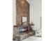 Living room boasts a stone fireplace and mantle with views of the open floorplan and architecture at 501 Manhattan Dr # 202, Boulder, CO 80303