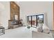 Living room with stone fireplace, sliding doors to a wood deck, and a comfortable sofa at 501 Manhattan Dr # 202, Boulder, CO 80303