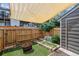 Enclosed backyard with a decorative fire pit, artificial turf and shade covering at 17108 E Whitaker Dr # B, Aurora, CO 80015