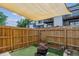 Enclosed backyard features artificial turf and a decorative fire pit under a shade covering at 17108 E Whitaker Dr # B, Aurora, CO 80015