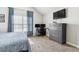 Bright bedroom with a large window, a dedicated desk space, and a matching dresser with a mounted TV at 17108 E Whitaker Dr # B, Aurora, CO 80015