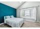 Bedroom boasts a striking accent wall, large windows, and ample natural light at 17108 E Whitaker Dr # B, Aurora, CO 80015