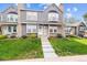 Charming townhouse featuring a well-manicured lawn, brick accents and steps leading to the front entrance at 17108 E Whitaker Dr # B, Aurora, CO 80015