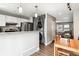 Open concept kitchen and dining area featuring modern appliances, lighting, and a stackable washer/dryer at 17108 E Whitaker Dr # B, Aurora, CO 80015
