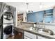 Modern kitchen features stainless steel appliances, updated countertops, and convenient washer and dryer at 17108 E Whitaker Dr # B, Aurora, CO 80015
