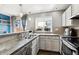Bright kitchen featuring concrete countertops, stainless steel appliances, and open window with natural light at 17108 E Whitaker Dr # B, Aurora, CO 80015