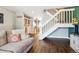 Open living room featuring wood floors, a staircase, and a view into the dining area at 17108 E Whitaker Dr # B, Aurora, CO 80015