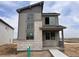 Modern two-story home showcasing a blend of gray siding and stone accents, enhancing its curb appeal at 24251 E 54Th Pl, Aurora, CO 80019