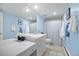 Stylish bathroom featuring blue walls, a large mirror, and a shower-tub combination with a patterned curtain at 5821 E Ithaca Pl, Denver, CO 80237