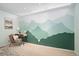 Creative mountain mural adds a touch of nature to this bedroom workspace at 5821 E Ithaca Pl, Denver, CO 80237