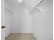 Walk-in closet with neutral carpeting, white walls, and metal clothing rods at 5821 E Ithaca Pl, Denver, CO 80237