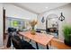 Open-concept dining and living area with hardwood floors and natural light at 5821 E Ithaca Pl, Denver, CO 80237