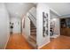 Bright entryway with wood floors, stairs to the upper level, and access to the dining area at 5821 E Ithaca Pl, Denver, CO 80237