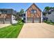 Charming Tudor-style townhome with a brick and white exterior, two-car garage, and well-manicured lawn at 5821 E Ithaca Pl, Denver, CO 80237