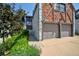Charming townhome with a brick and white exterior, a two-car garage, and manicured landscaping at 5821 E Ithaca Pl, Denver, CO 80237