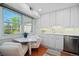 Bright and modern eat-in kitchen featuring white cabinets and a cozy breakfast nook with a window at 5821 E Ithaca Pl, Denver, CO 80237