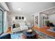 Living area with hardwood floors, stylish decor, and lots of natural light at 5821 E Ithaca Pl, Denver, CO 80237