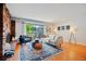 Bright living room with hardwood floors, comfy seating, and access to the balcony at 5821 E Ithaca Pl, Denver, CO 80237