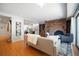 Comfortable living area features hardwood floors, fireplace, and an open layout to the dining area at 5821 E Ithaca Pl, Denver, CO 80237