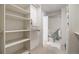 Spacious walk-in closet with custom shelving and seating, maximizing organization and functionality at 5821 E Ithaca Pl, Denver, CO 80237