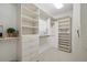 Organized walk-in closet with built-in shelves and drawers, offering ample storage space at 5821 E Ithaca Pl, Denver, CO 80237