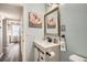 Bathroom with a white vanity, a framed mirror, and light blue walls at 1005 S Miller St # 102, Lakewood, CO 80226