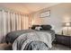 Comfortable bedroom featuring a cozy bed with stylish gray bedding, side table, and wall art at 1005 S Miller St # 102, Lakewood, CO 80226