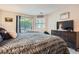 Comfortable bedroom with a cozy bed, dark wood dresser, and natural light, creating a peaceful retreat for rest at 1005 S Miller St # 102, Lakewood, CO 80226