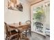 Charming dining area with a rustic table, cozy seating, and a sliding door to a private outdoor patio space at 1005 S Miller St # 102, Lakewood, CO 80226