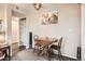 This dining area features a wood table, cozy seating, and easy access to a storage area, maximizing functionality at 1005 S Miller St # 102, Lakewood, CO 80226