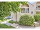 Charming exterior view of a townhouse with well-maintained landscaping and mature trees at 1005 S Miller St # 102, Lakewood, CO 80226