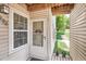 Inviting front door with decorative wreath, window, and potted plants, welcoming guests at 1005 S Miller St # 102, Lakewood, CO 80226
