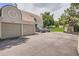 Exterior view of the townhome highlighting the two-car garage and ample parking at 1005 S Miller St # 102, Lakewood, CO 80226