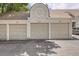 Exterior of garages showing multiple bays, with the unit numbers clearly marked on the facade at 1005 S Miller St # 102, Lakewood, CO 80226