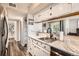 The kitchen boasts white cabinets, marble countertops, stainless steel appliances, and convenient access to the living area at 1005 S Miller St # 102, Lakewood, CO 80226