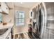 Bright kitchen featuring stainless steel appliances, white cabinets, and modern fixtures, perfect for cooking and entertaining at 1005 S Miller St # 102, Lakewood, CO 80226
