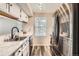 Well-lit kitchen featuring stainless steel appliances, marble countertops, and white cabinets, ideal for culinary enthusiasts at 1005 S Miller St # 102, Lakewood, CO 80226