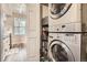 Laundry area with modern, stacked washer and dryer, located near the kitchen at 1005 S Miller St # 102, Lakewood, CO 80226