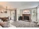 Cozy living room with a brick fireplace, soft carpet, and ample natural light at 1005 S Miller St # 102, Lakewood, CO 80226
