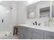 Modern bathroom with subway tile shower, gray vanity and patterned tile flooring at 11916 S Meander Way, Parker, CO 80138