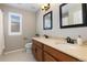 Bathroom with dual sinks, granite countertop, and dark wood cabinets at 11916 S Meander Way, Parker, CO 80138