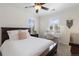 Bedroom with a large bed, ceiling fan, writing desk, and plenty of natural light at 11916 S Meander Way, Parker, CO 80138