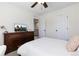 Bright bedroom featuring a ceiling fan, and a wooden dresser with a flatscreen TV at 11916 S Meander Way, Parker, CO 80138