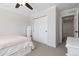 Cozy bedroom featuring a ceiling fan, large closet with mirrored doors, and plush carpet at 11916 S Meander Way, Parker, CO 80138